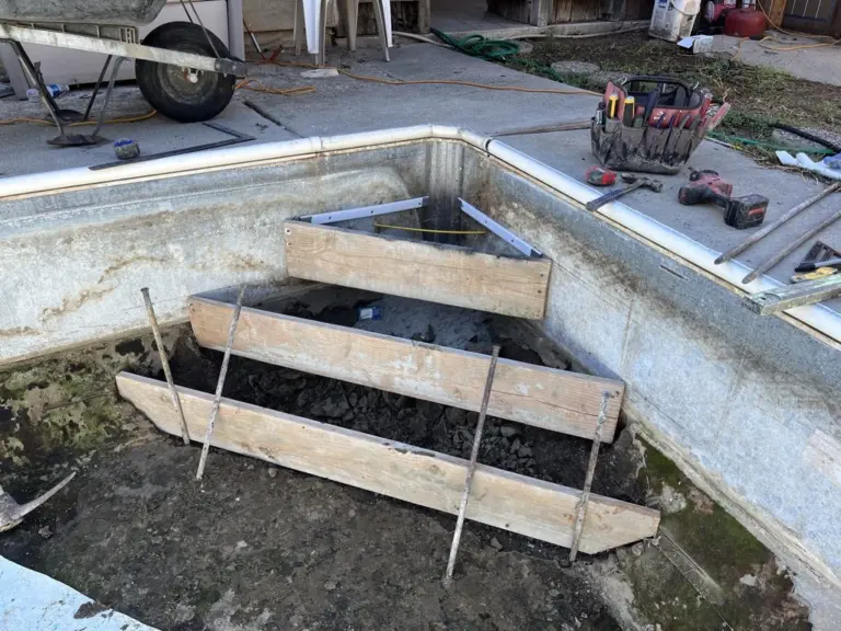 Project 1: wood forms set in the corner for new poured steps