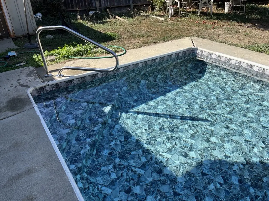 Project 1, finished: the pool filled, new steps and handrail under clear water