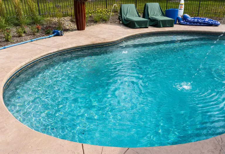 Oval pool in the Savannah liner with clear blue water and a concrete deck
