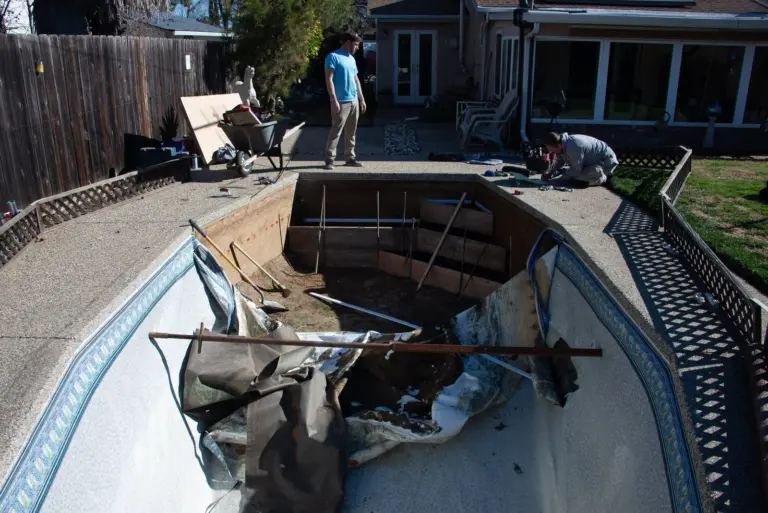The pool with the step forms in place and the old liner still in the deep end