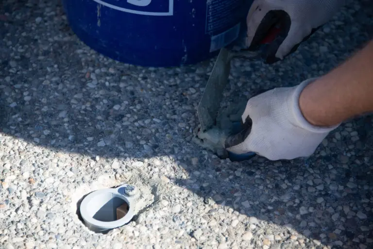 Setting a handrail anchor cup into the deck with fresh concrete