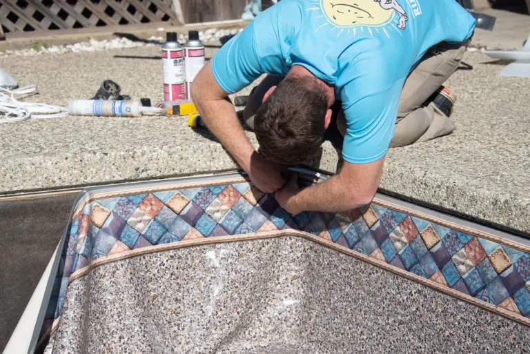 Hooking the new liner bead into the track under the coping