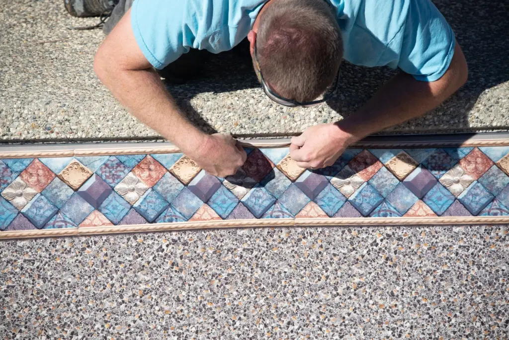Close-up: hands pressing the liner bead into the track
